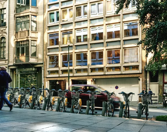 Brussels street scene showcasing a bike sharing station against a backdrop of urban buildings