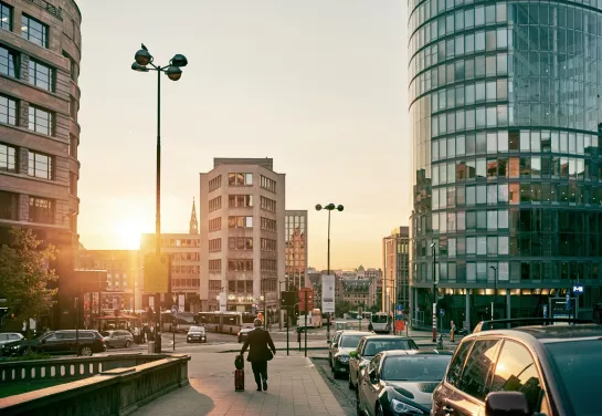 Rue de Loxum in Brussels with Central Plaza building and the skyline in the background under a radiant sunset