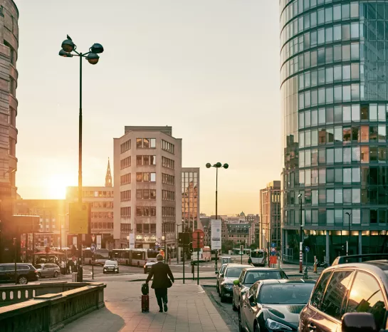 Rue de Loxum in Brussels with Central Plaza building and the skyline in the background under a radiant sunset