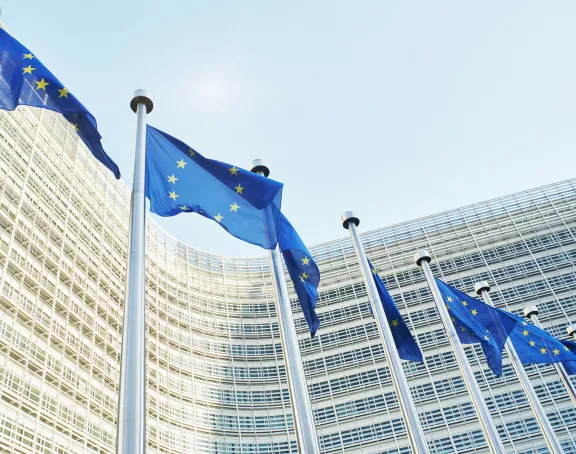 European flags waving in front of the European Parliament in Brussels