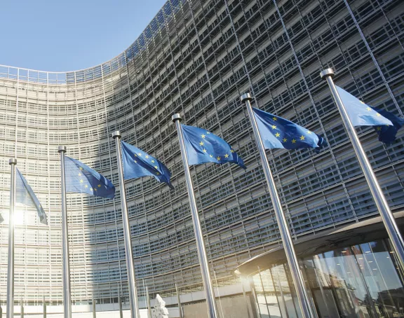 European flags waving in front of the European Parliament in Brussels