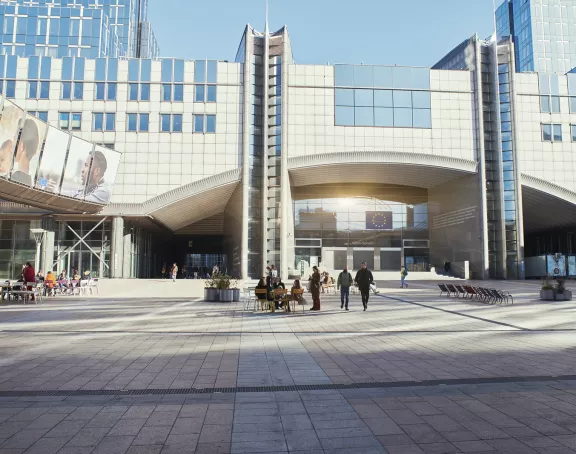 People sitting together and socializing in front of the European Parliament in Brussels