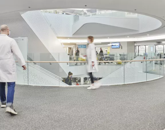 Staff members and visitors walking around a hospital