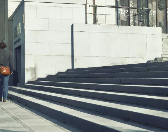  Pedestrians descending steps and walking along the pavement at Mont des Arts in Brussels