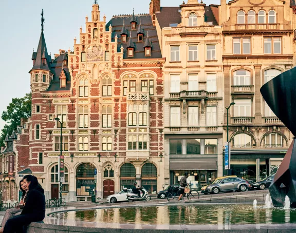Charming street in Brussels with a fountain in the foreground and captivating historic architecture in the background