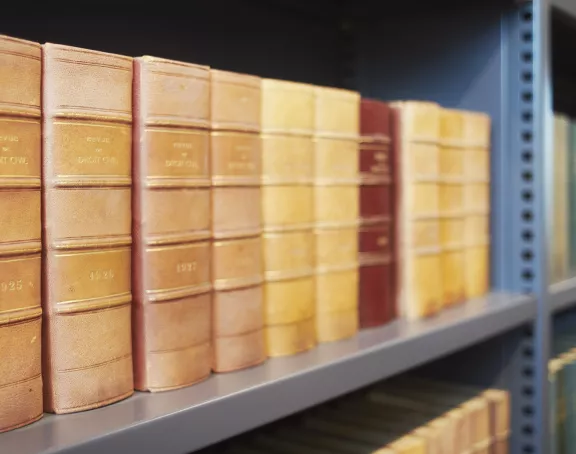 Close-up of law codes on a bookshelf in the library of Stibbe in Brussels