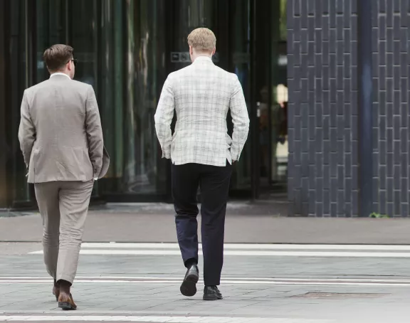 Businessmen walking towards office building