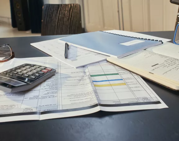 Desk with papers and calculator