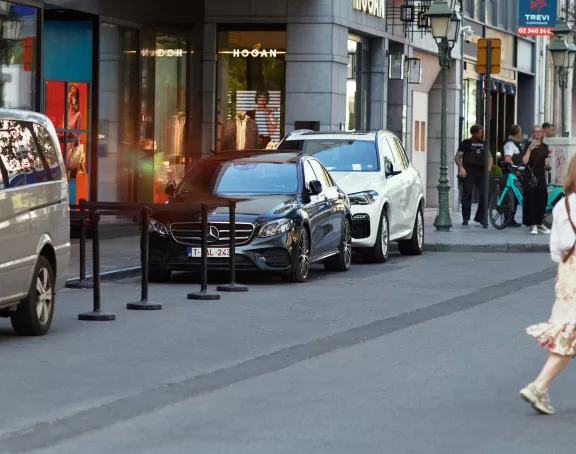 Woman with shopping bag crossing the shopping street 'Boulevard de Waterloo' in Brussels