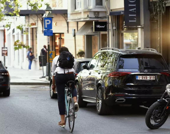 street in brussels with guy on bike and cars