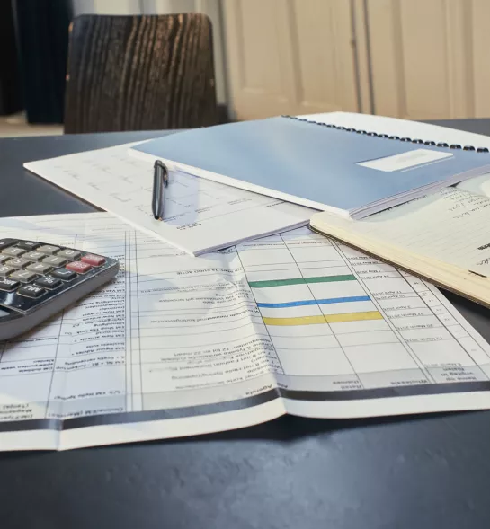 Desk with papers and calculator