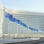 European flags waving in front of the European Parliament in Brussels
