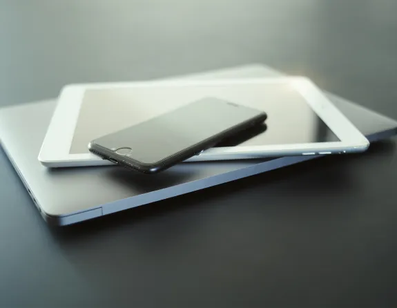 Laptop, iPad and iPhone stacked on each other