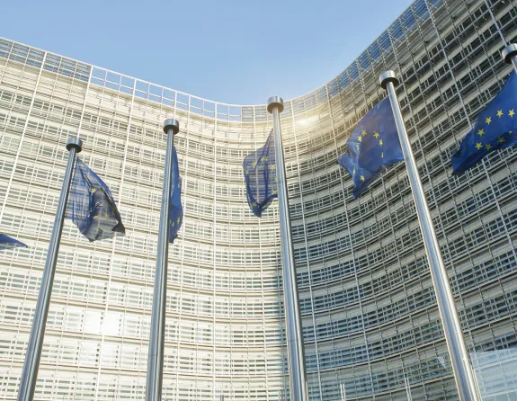 European flags waving in front of the European Parliament in Brussels