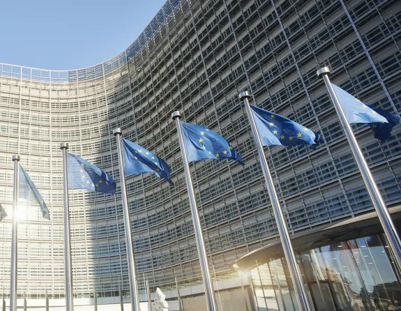 European flags waving in front of the European Parliament in Brussels