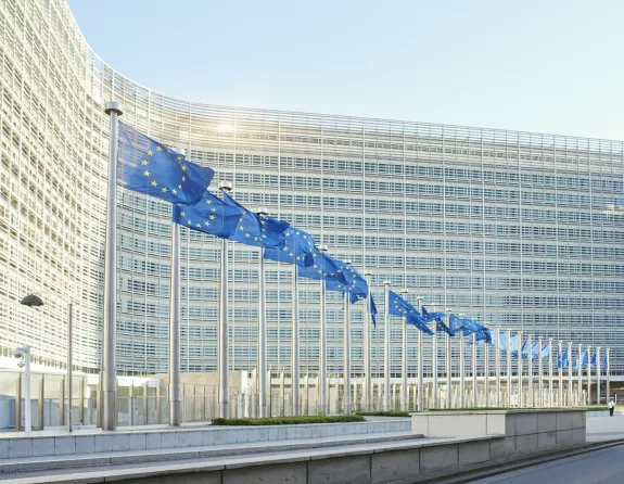 European flags waving in front of the European Parliament in Brussels