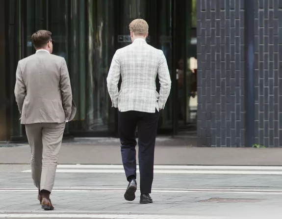 Businessmen walking towards office building