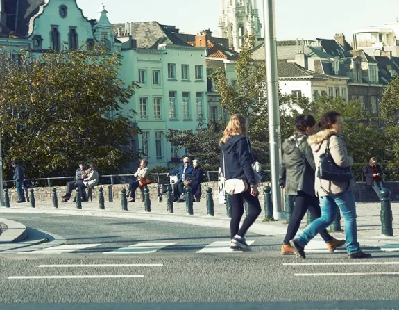 Lively square in Brussels filled with pedestrians and people soaking up the sun