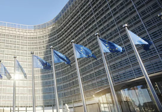 European flags waving in front of the European Parliament in Brussels